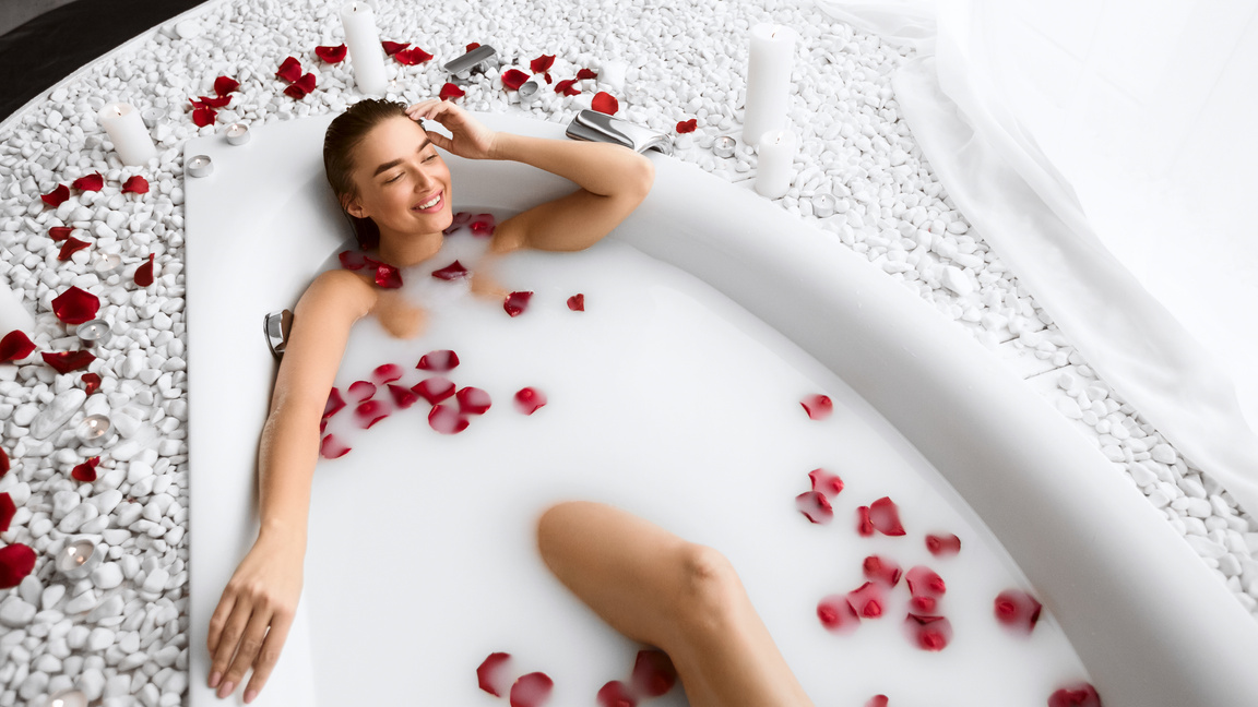 Girl Relaxing In Flower Milk Bath In Resort Spa Salon